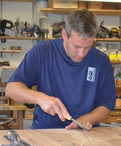 Adam Ross working on custom wood door